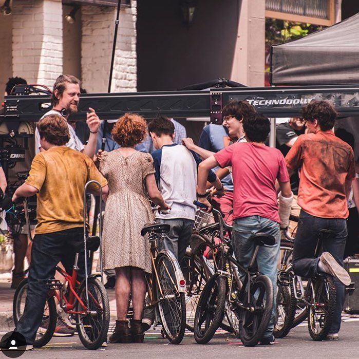 a group of people standing next to each other on bicycles