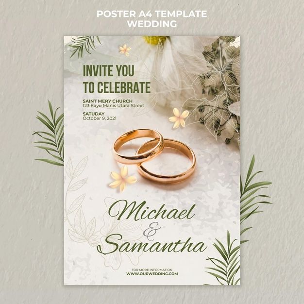 two gold wedding rings on top of each other in front of flowers and greenery