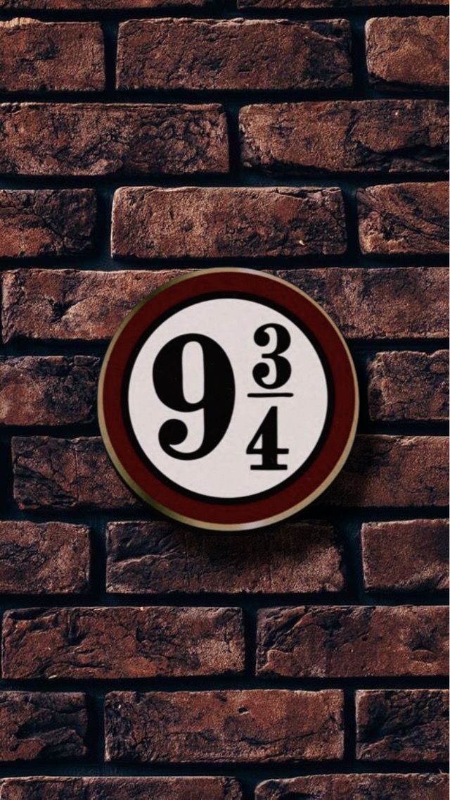 a brick wall with a sign on it that reads 9 / 4 and has the number nine