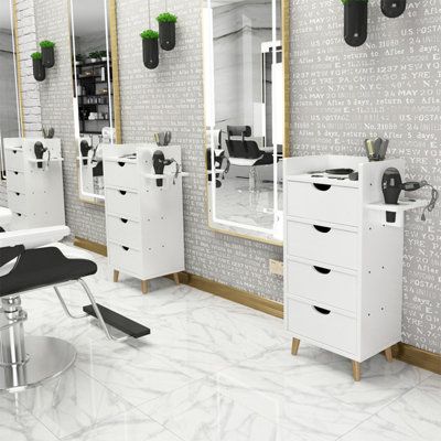 a salon with chairs, mirrors and hair dryers on the wall next to each other