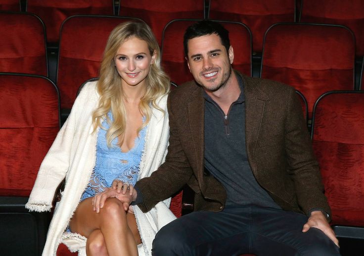 a man sitting next to a woman in front of a red velvet theater seat, smiling at the camera