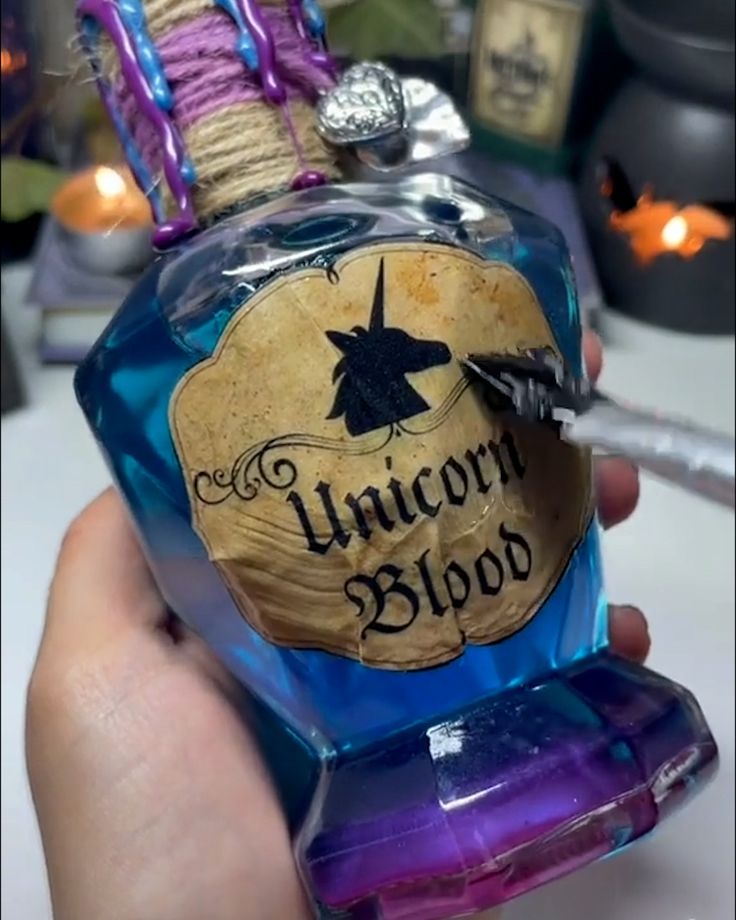 someone is holding a bottle of unicorn blood