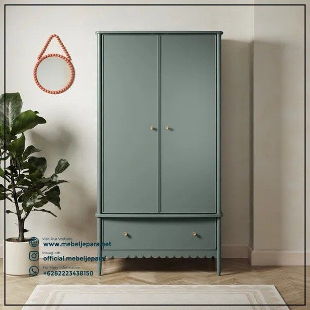 a blue armoire next to a potted plant in a room with white walls