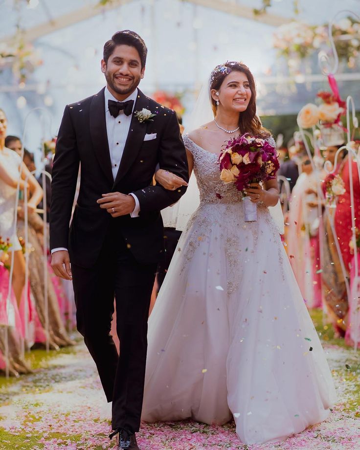 a bride and groom walking down the aisle after their wedding ceremony at an outdoor venue