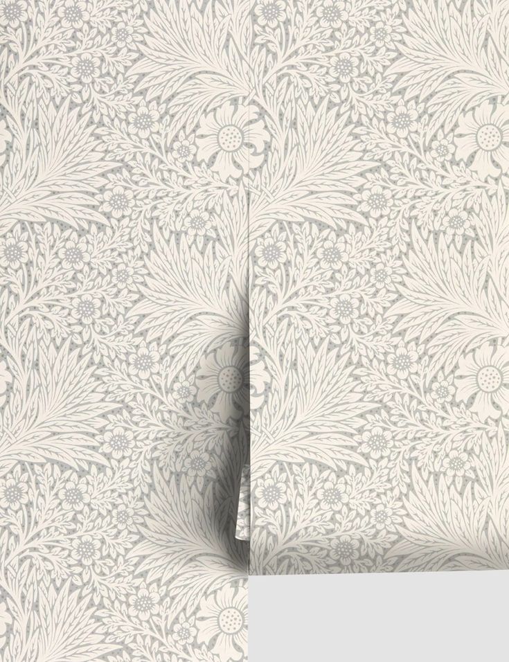 a white wallpaper with an intricate floral design on the front and back side of it