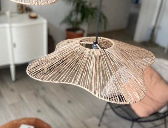 two wicker lamps hanging from the ceiling in a living room