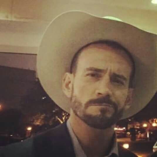 a man with a beard wearing a cowboy hat