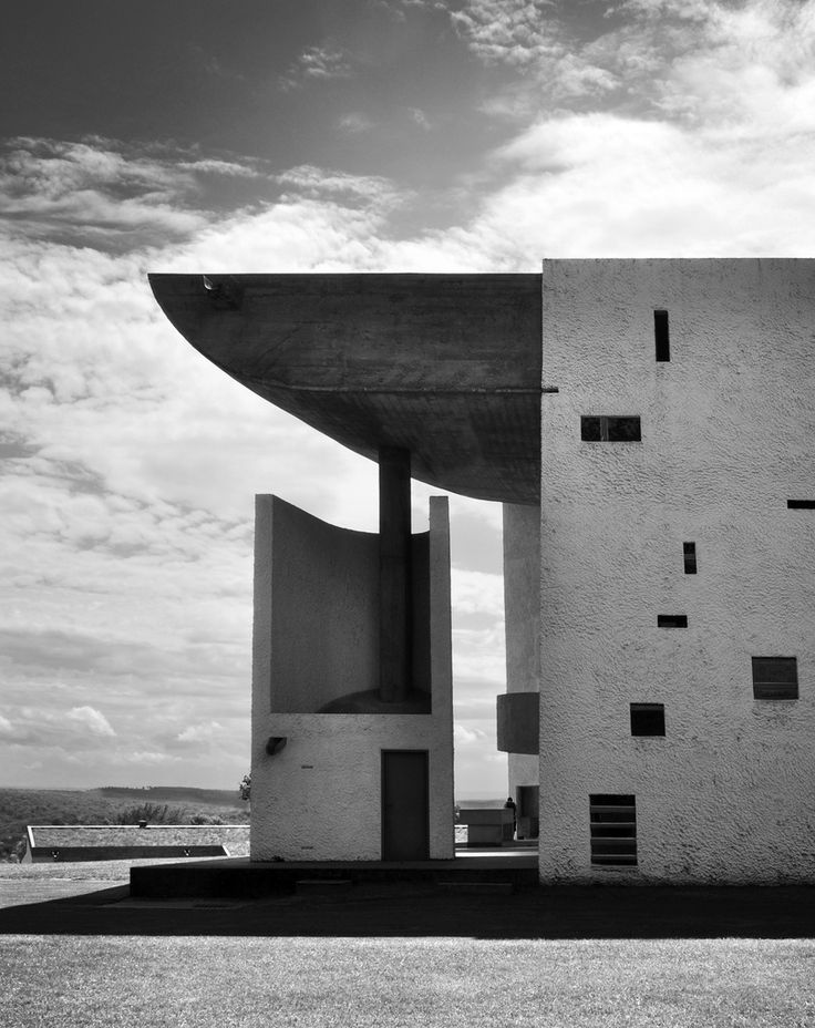 black and white photograph of the exterior of a building with an unusual design on it