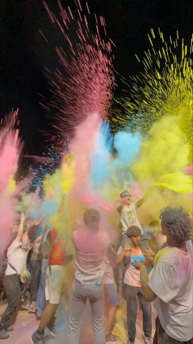people are throwing colored powder on each other