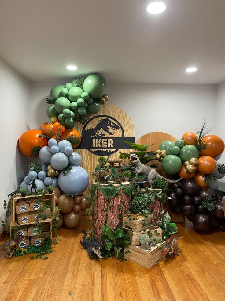 a room filled with balloons and decorations on top of hard wood flooring next to a sign that says tiger