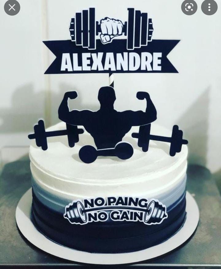 there is a cake decorated with a man's body and barbells on it