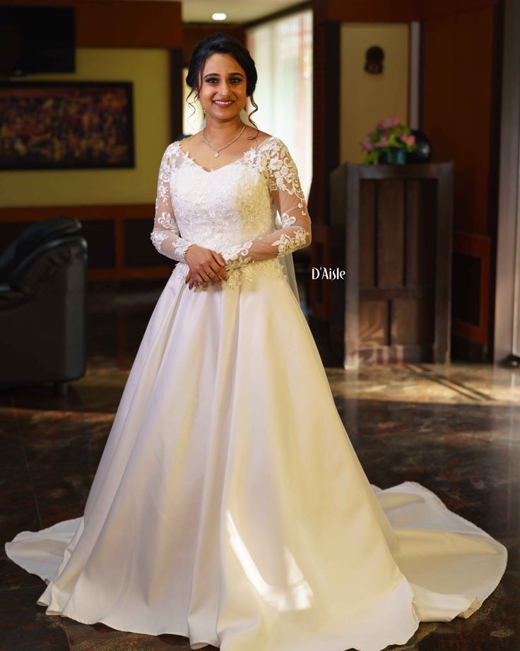 a woman in a wedding dress posing for the camera