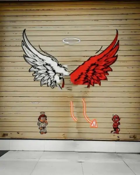 a garage door with graffiti on it and an eagle painted on the side in red