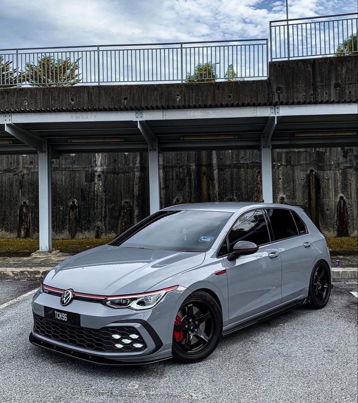 a grey car parked in front of a building