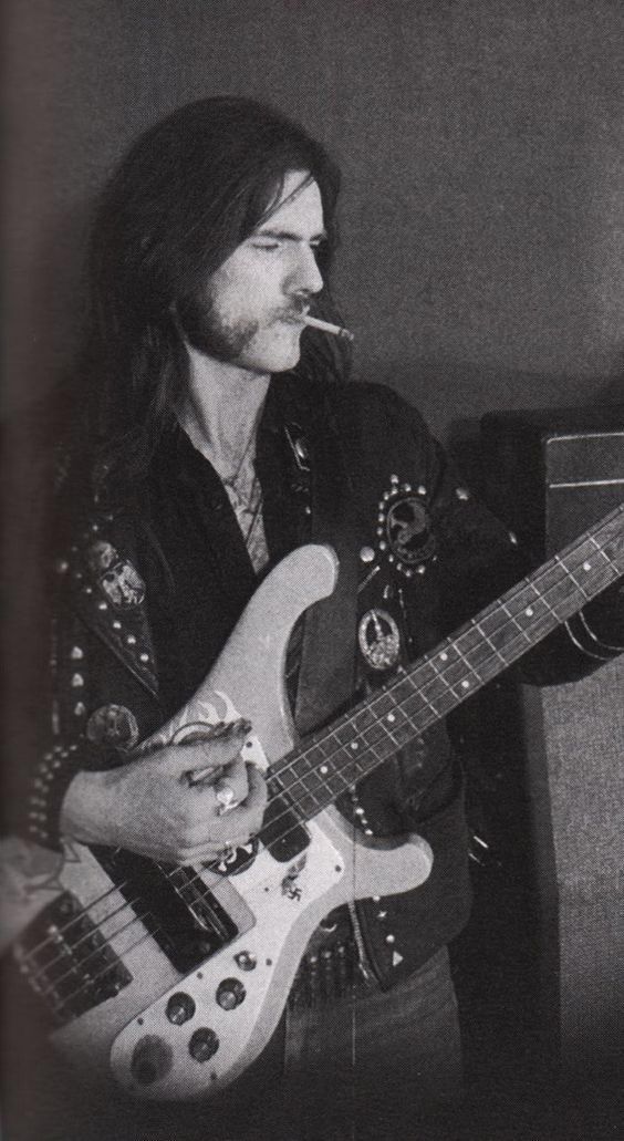 a man with long hair is playing an electric guitar in a black and white photo