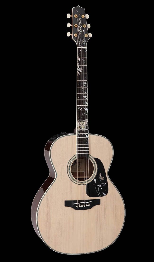 an acoustic guitar is shown against a black background