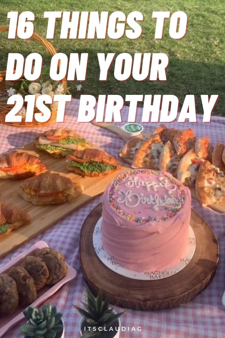 there is a pink cake on the table with other foods and desserts around it