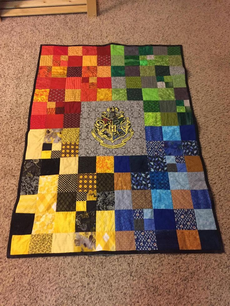 the four houses and hogwarts crest quilt is on display in this screen shot