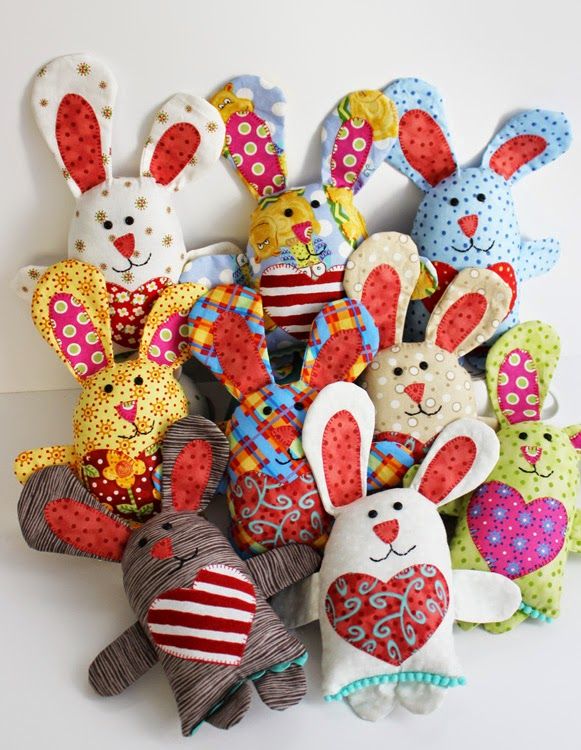 a pile of stuffed animals sitting next to each other on a white surface with polka dots