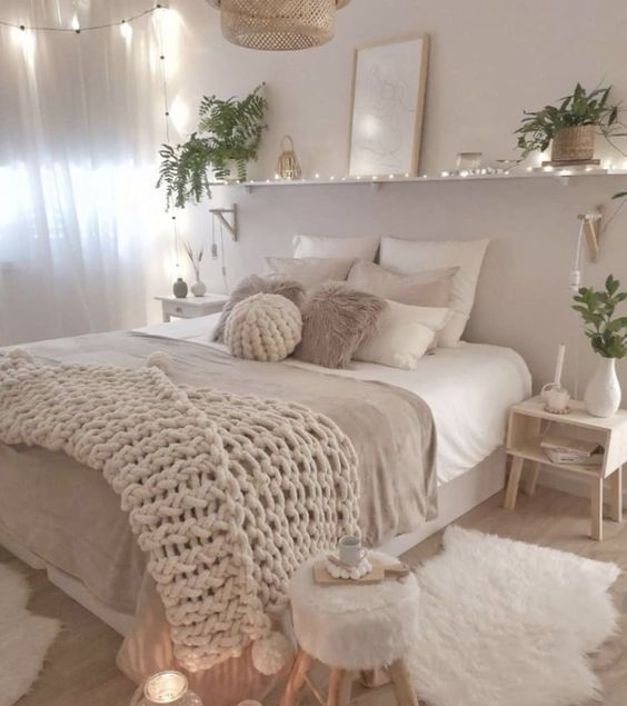 a bedroom decorated in neutral tones and white