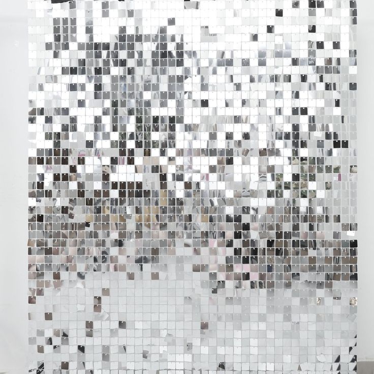 a white wall covered in lots of square tiles