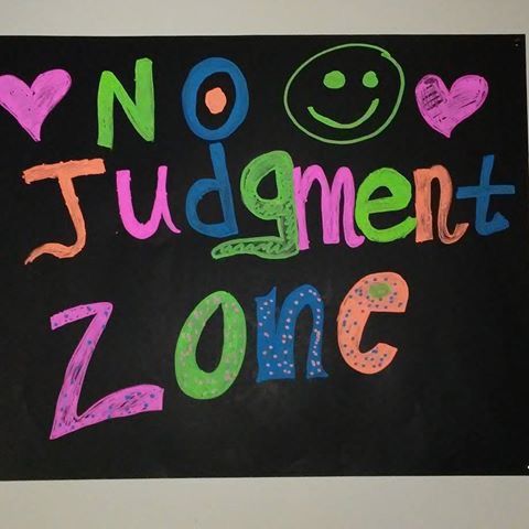 a sign that says no student zone with smiley faces and words written in multicolored letters