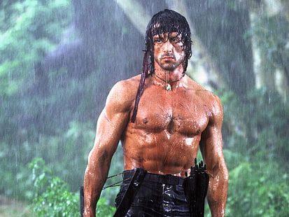 a man with no shirt on in the rain