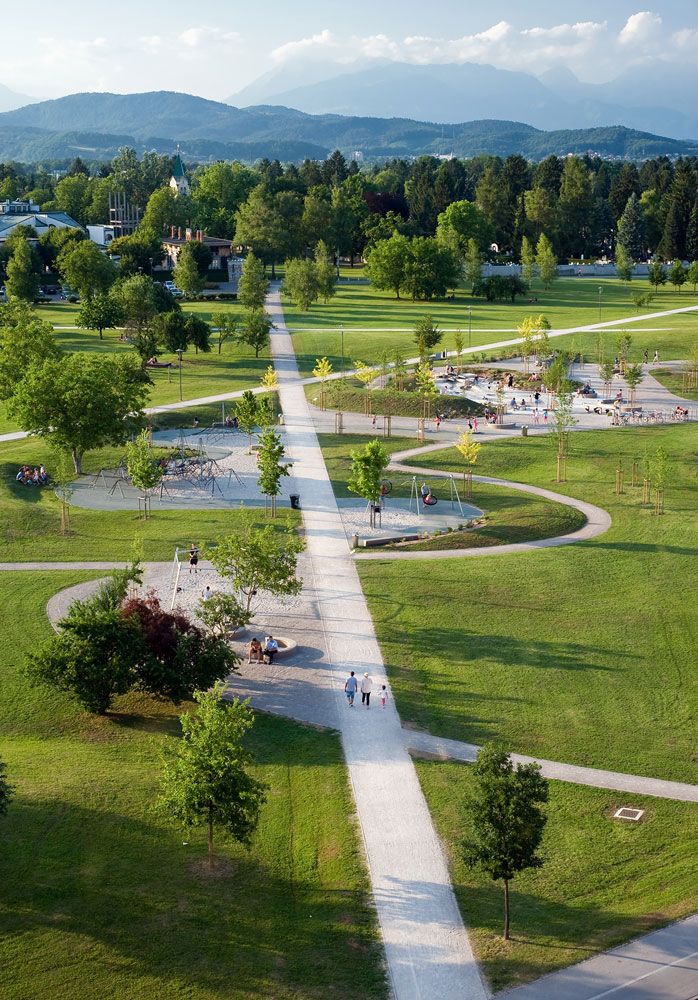 an aerial view of a park with many trees and people walking on the walkways