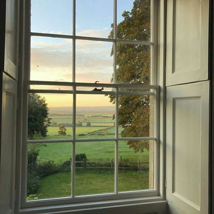 an open window looking out onto the countryside