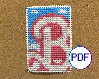 a needled art piece featuring the los angeles angels logo in red, white and blue