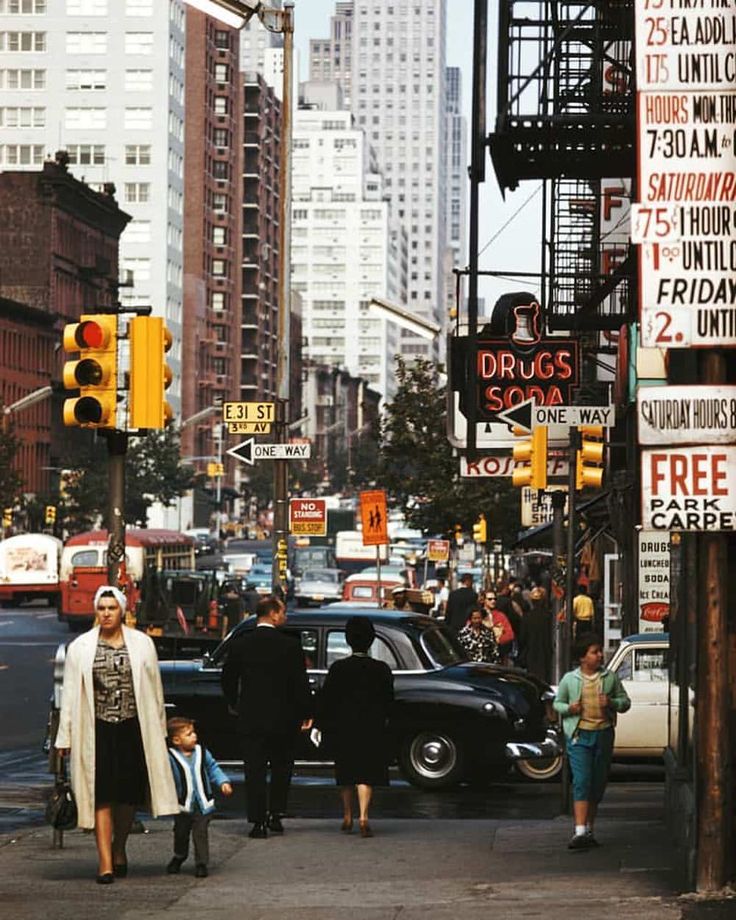 people are walking down the street in new york city