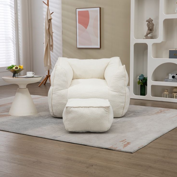 a white chair and ottoman in a living room