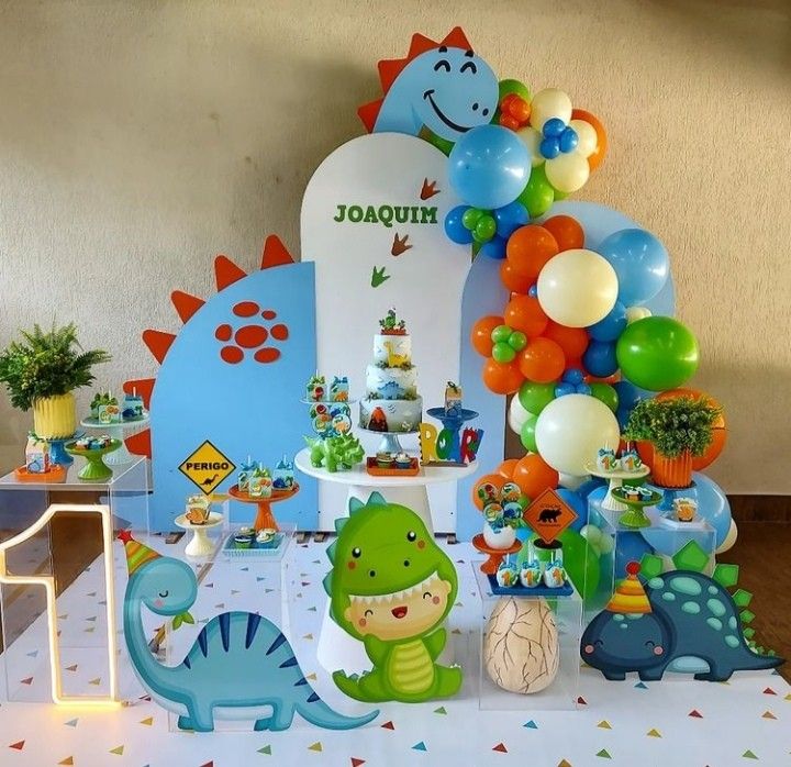 a dinosaur themed birthday party with balloons and decorations