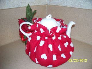 a red and white polka dot tea pot cover