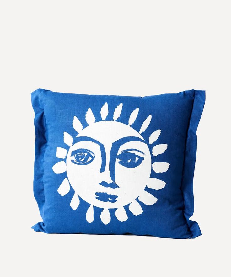 a blue and white pillow with an image of a woman's face on it