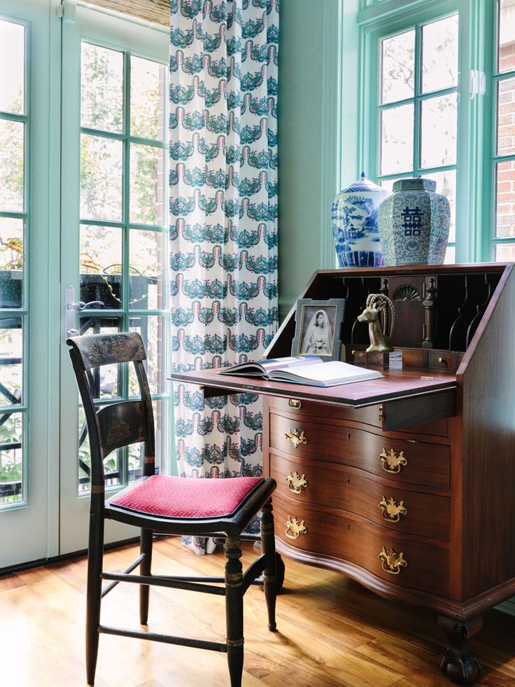 a desk and chair in a room with blue walls