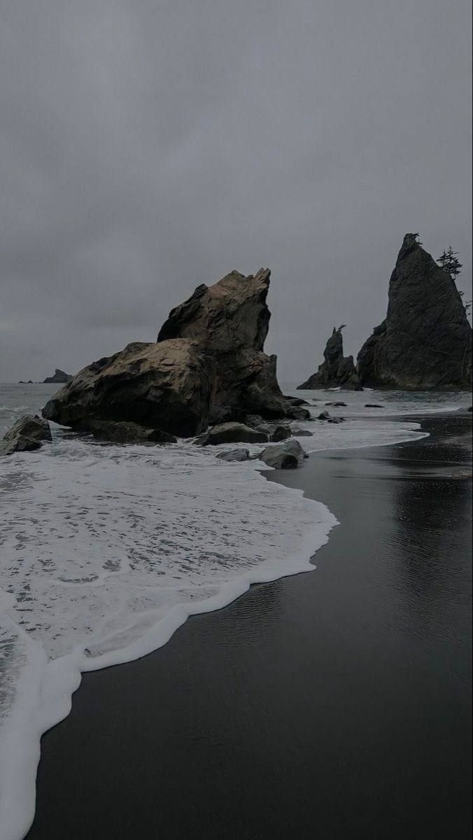 some rocks in the water on a cloudy day