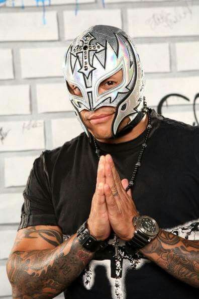 a man wearing a wrestling mask and praying