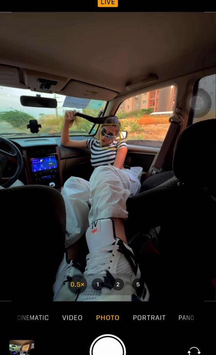 a person laying in the back seat of a car