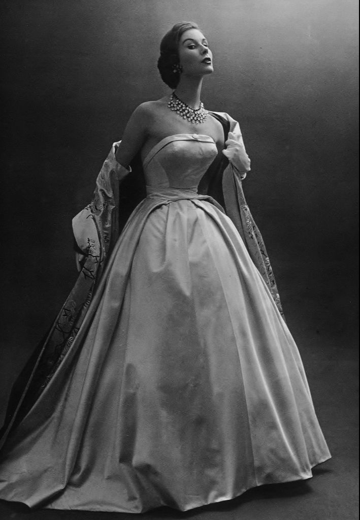 a black and white photo of a woman in a gown