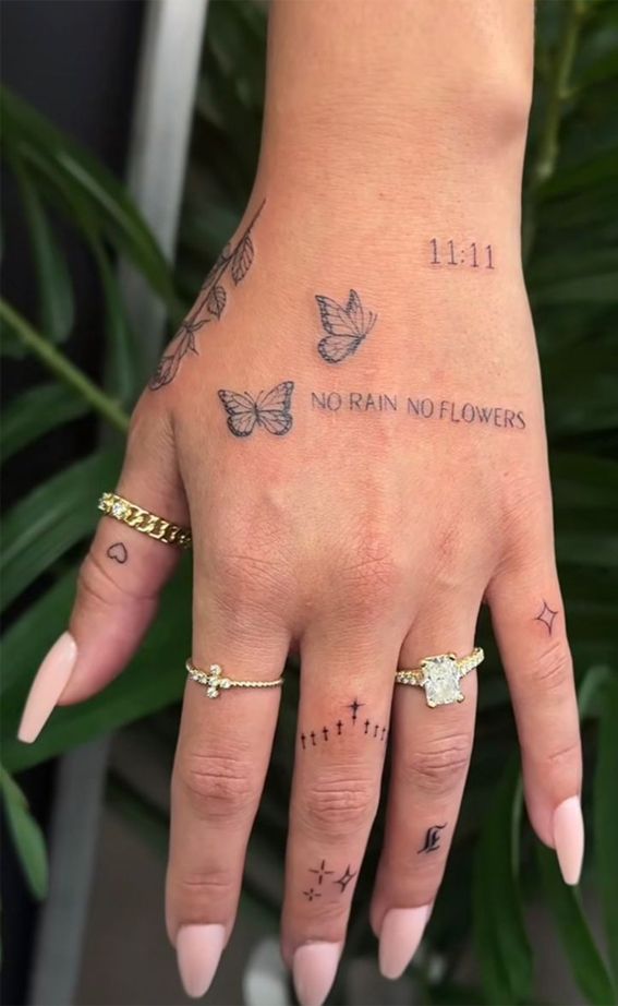 a woman's hand with tattoos on it