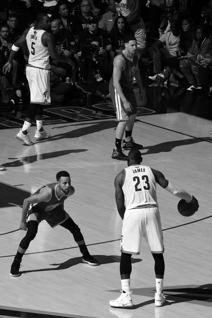 black and white photograph of basketball players on court