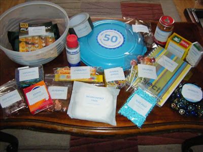 an assortment of items that are sitting on a wooden table in front of a plastic container