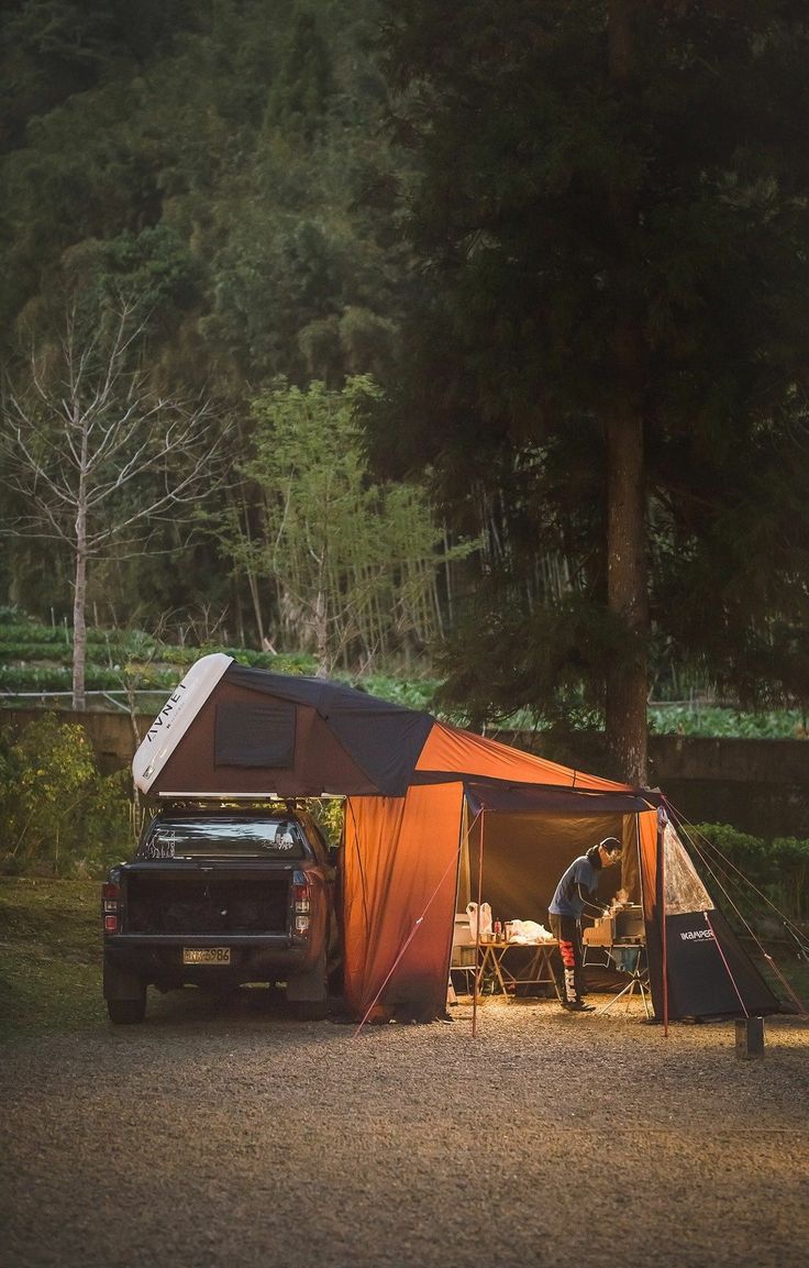 a truck is parked next to a tent