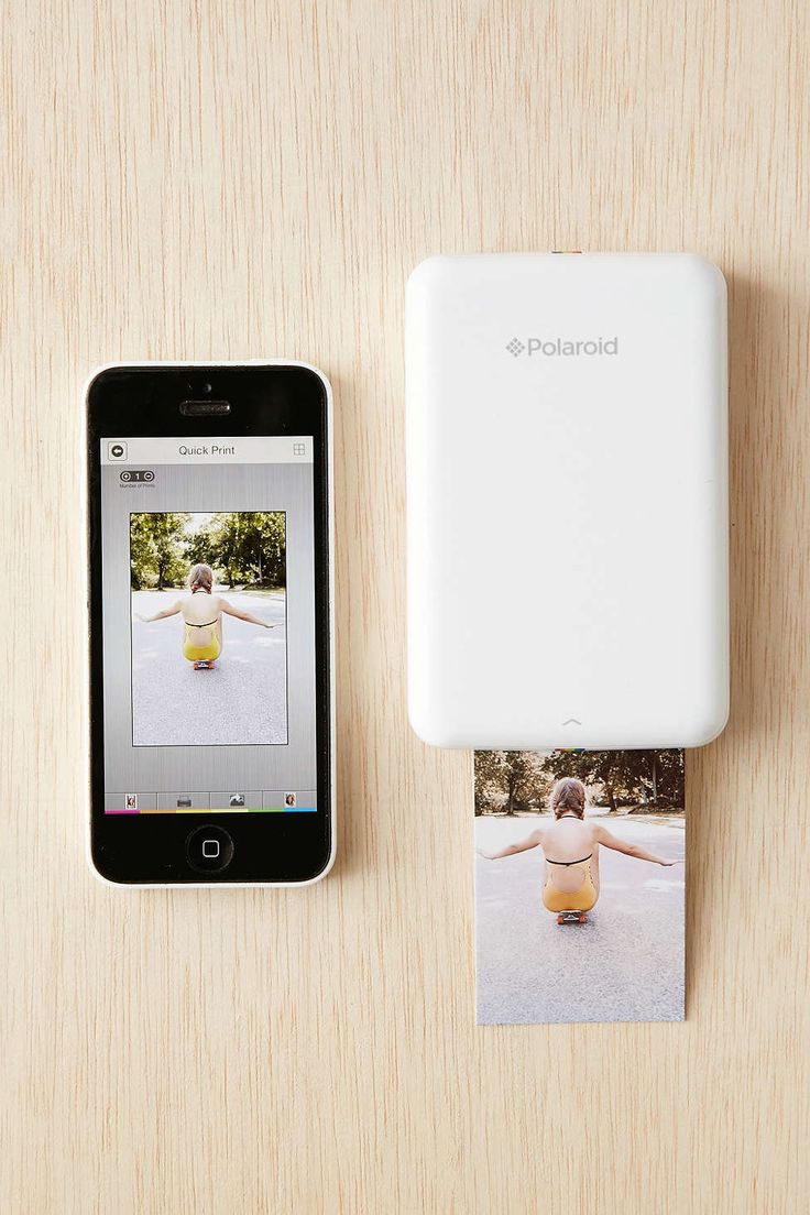 a polaroid photo printer next to an iphone