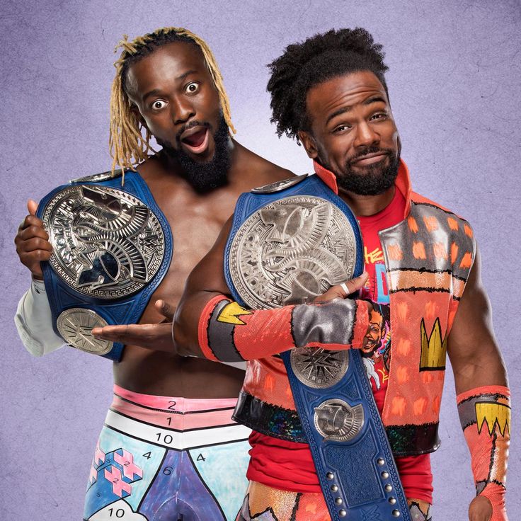 two men in wrestling gear posing for the camera