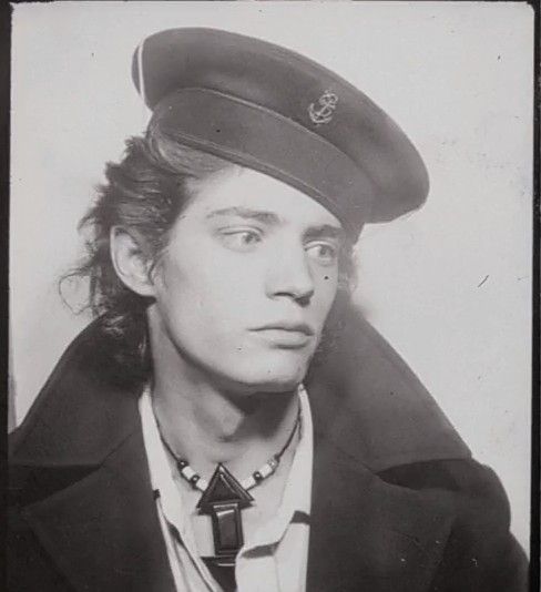 black and white photograph of a man wearing a hat