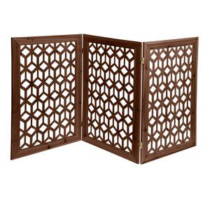 an open wooden screen with geometric designs on the inside and outside, in dark brown