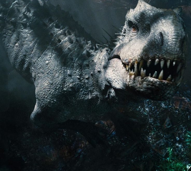 a close up of a dinosaur with its mouth open and sharp teeth showing, in the dark