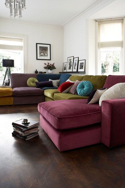 a living room filled with furniture and lots of windows